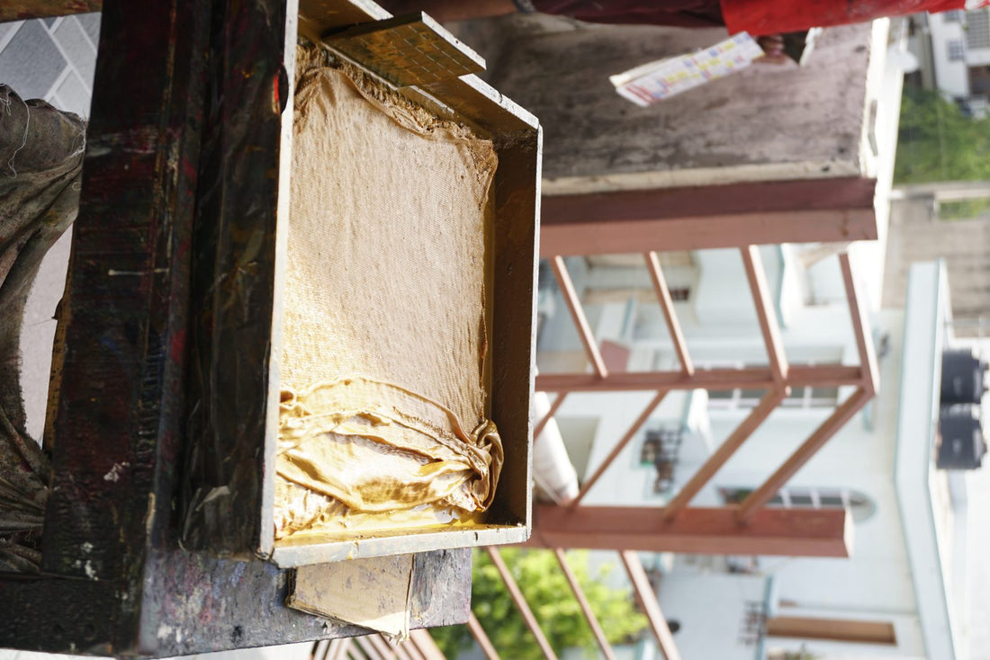 Artisan working organic cotton fabric in a natural dye bath at Myyra Jaipur