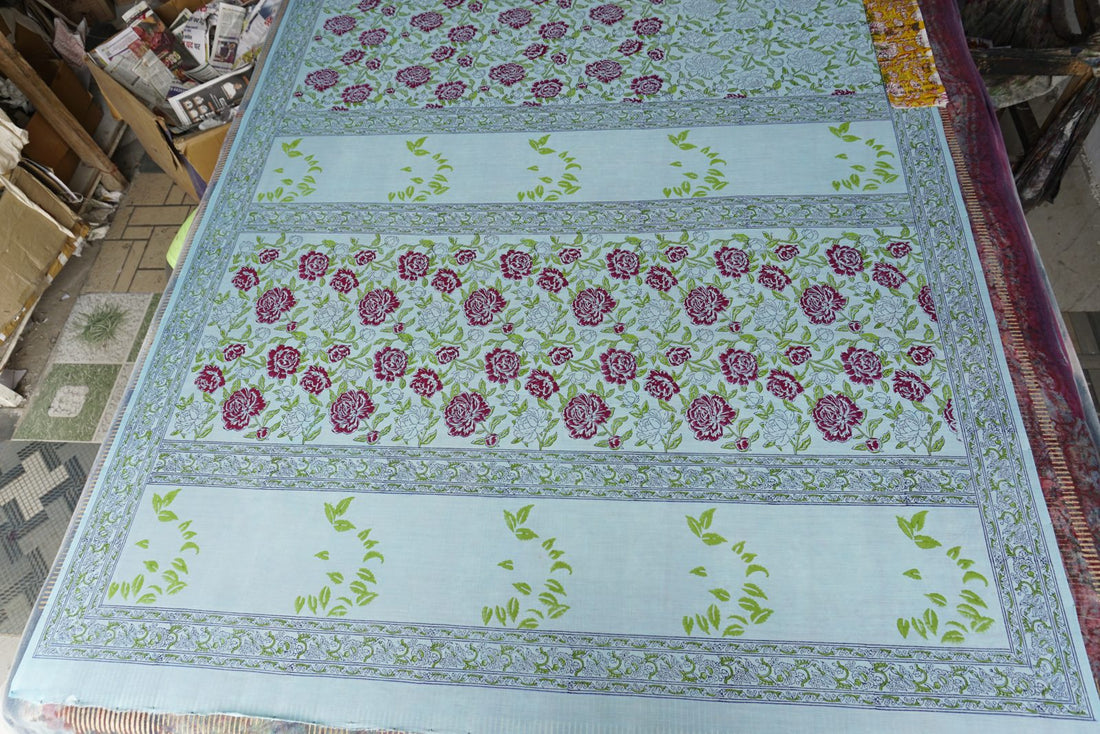 Overview of hand block printed peony fabric on the workshop table | Myyra Jaipur