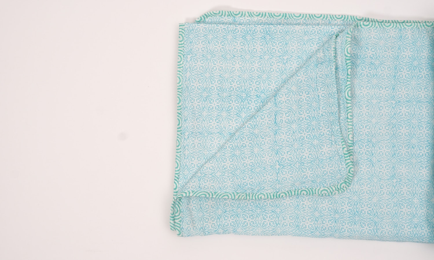 Dohar (lightweight cotton quilt) folded showing pattern repeat of hand block print | Myyra Jaipur