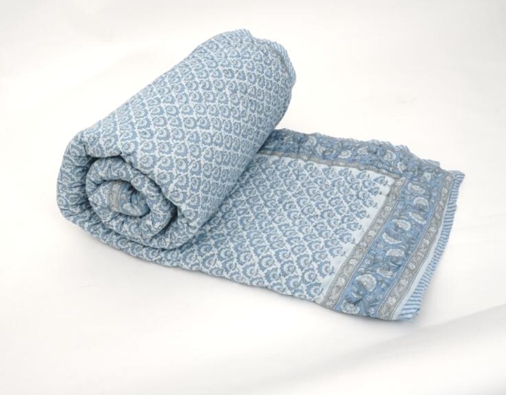 Folded organic cotton quilt showing block printed repeat | Myyra Jaipur