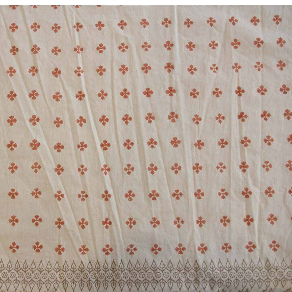 Folded hand block printed organic cotton yardage showing pattern repeat | Myyra Jaipur