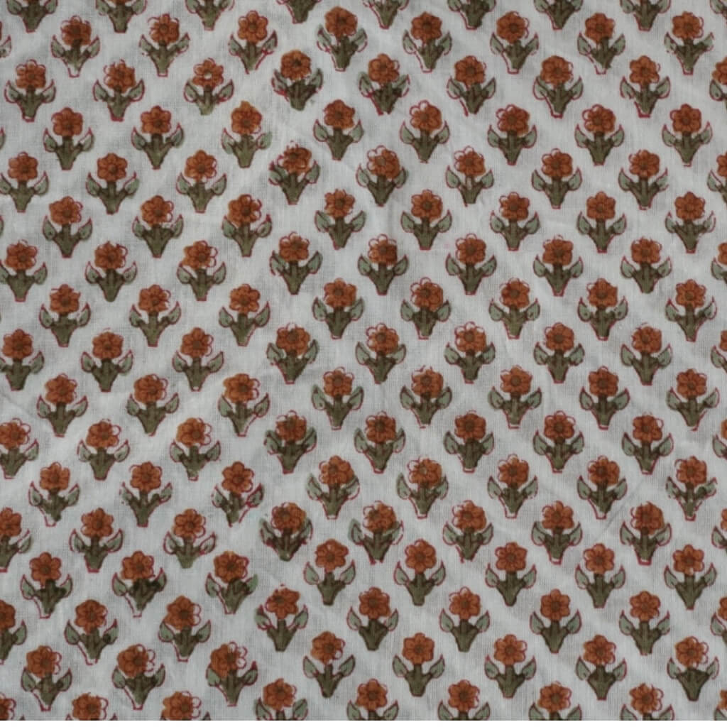 Folded hand block printed organic cotton yardage showing pattern repeat | Myyra Jaipur