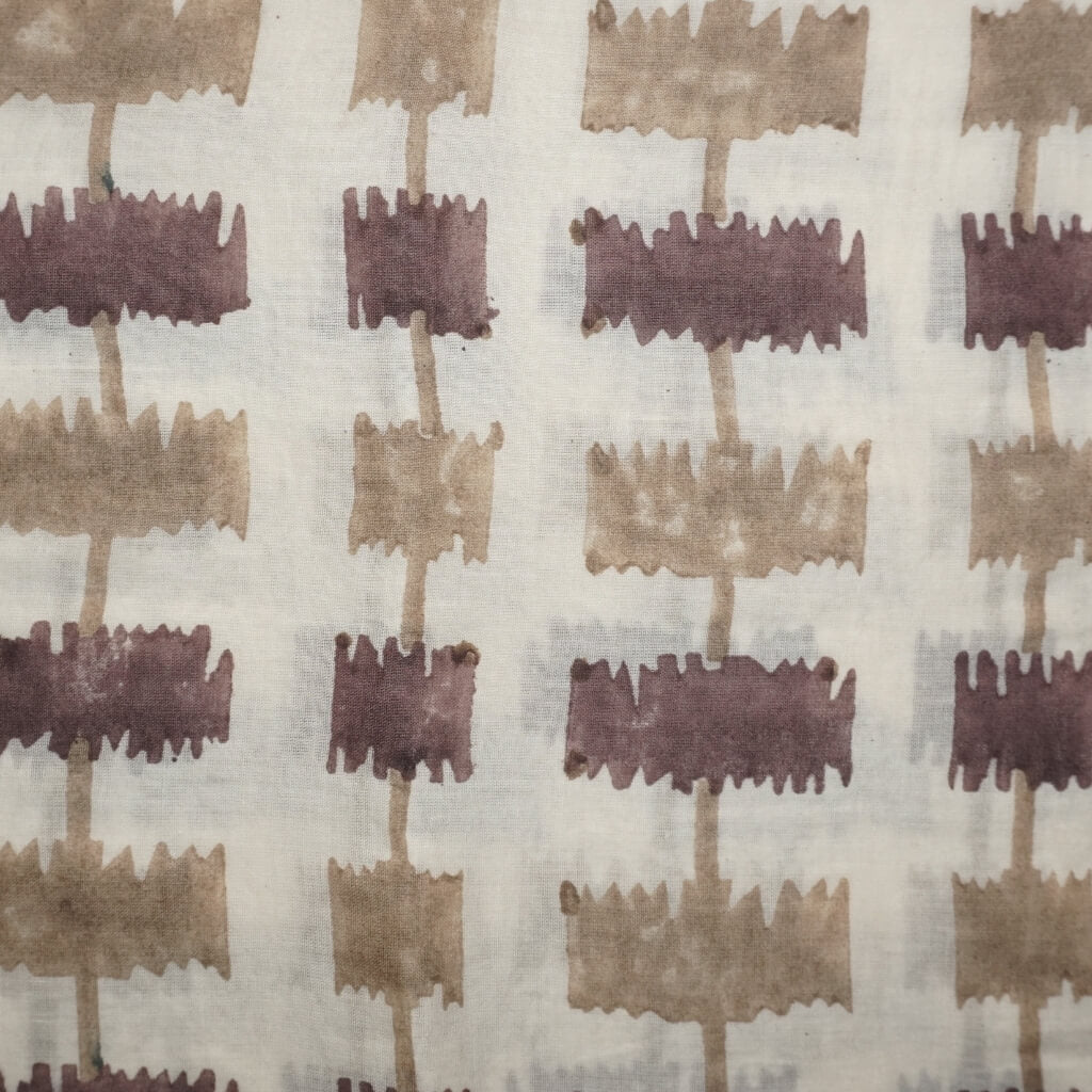 Folded hand block printed organic cotton yardage showing pattern repeat | Myyra Jaipur