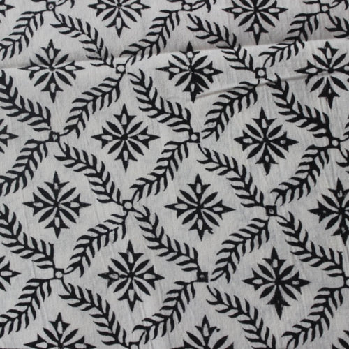 Folded hand block printed organic cotton yardage showing pattern repeat | Myyra Jaipur
