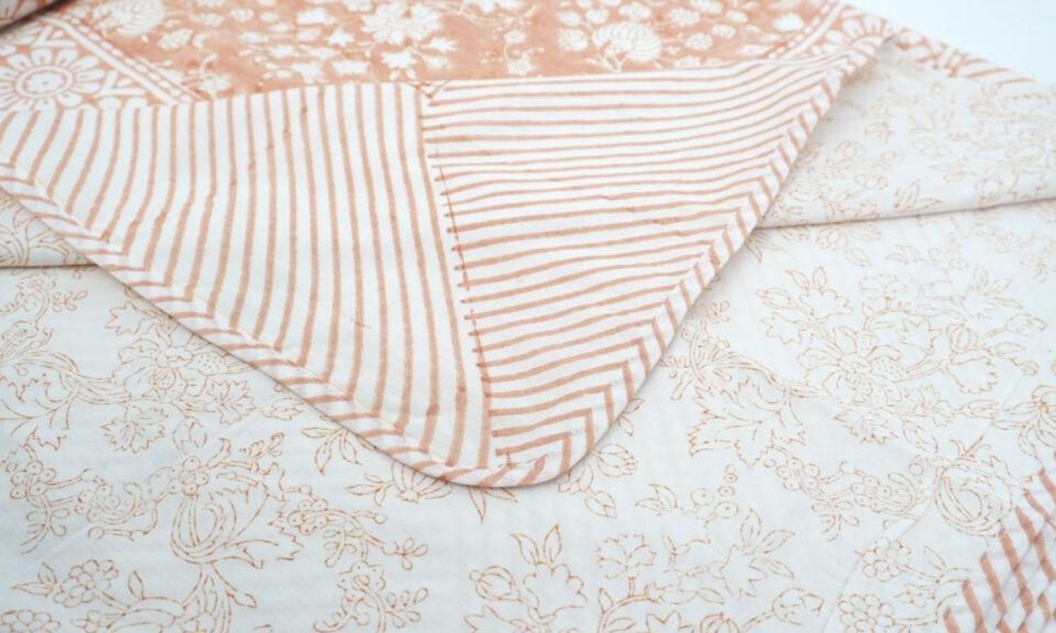 Dohar (lightweight cotton quilt) folded showing pattern repeat of hand block print | Myyra Jaipur