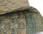 Folded organic cotton quilt showing block printed repeat | Myyra Jaipur