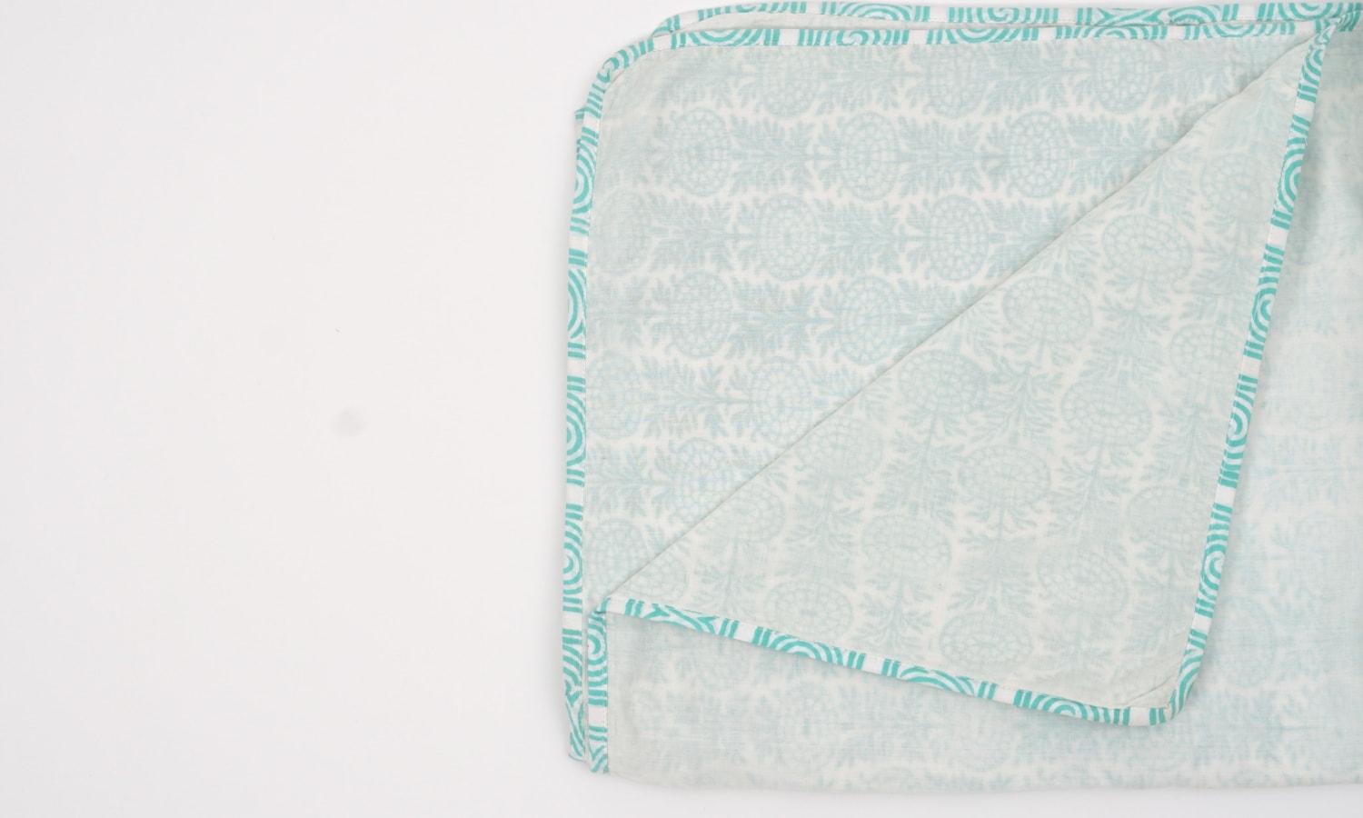 Dohar (lightweight cotton quilt) folded showing pattern repeat of hand block print | Myyra Jaipur