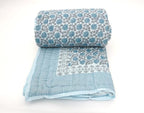 Folded organic cotton quilt showing block printed repeat | Myyra Jaipur