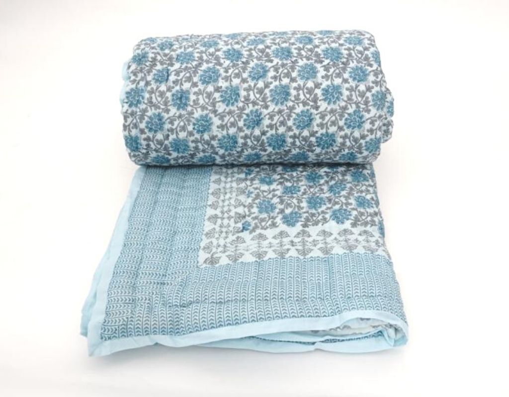 Folded organic cotton quilt showing block printed repeat | Myyra Jaipur