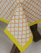 Close-up of yellow and orange hand block print on organic cotton table cover | Myyra Jaipur