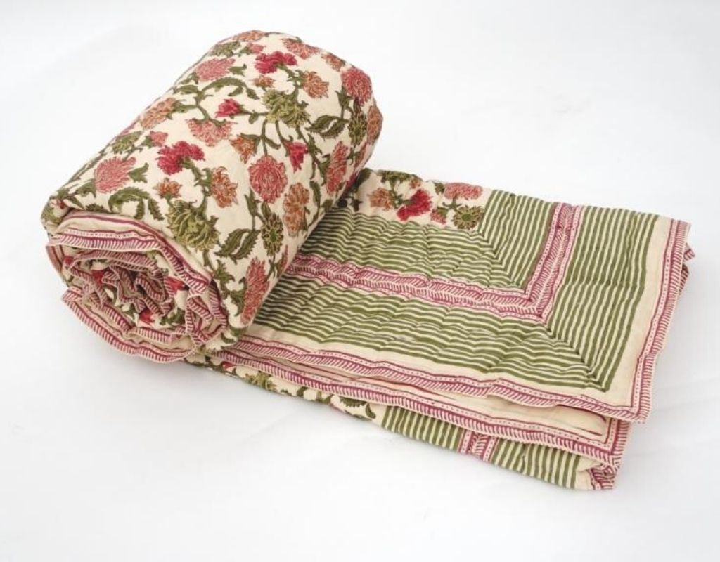 Folded organic cotton quilt showing block printed repeat | Myyra Jaipur