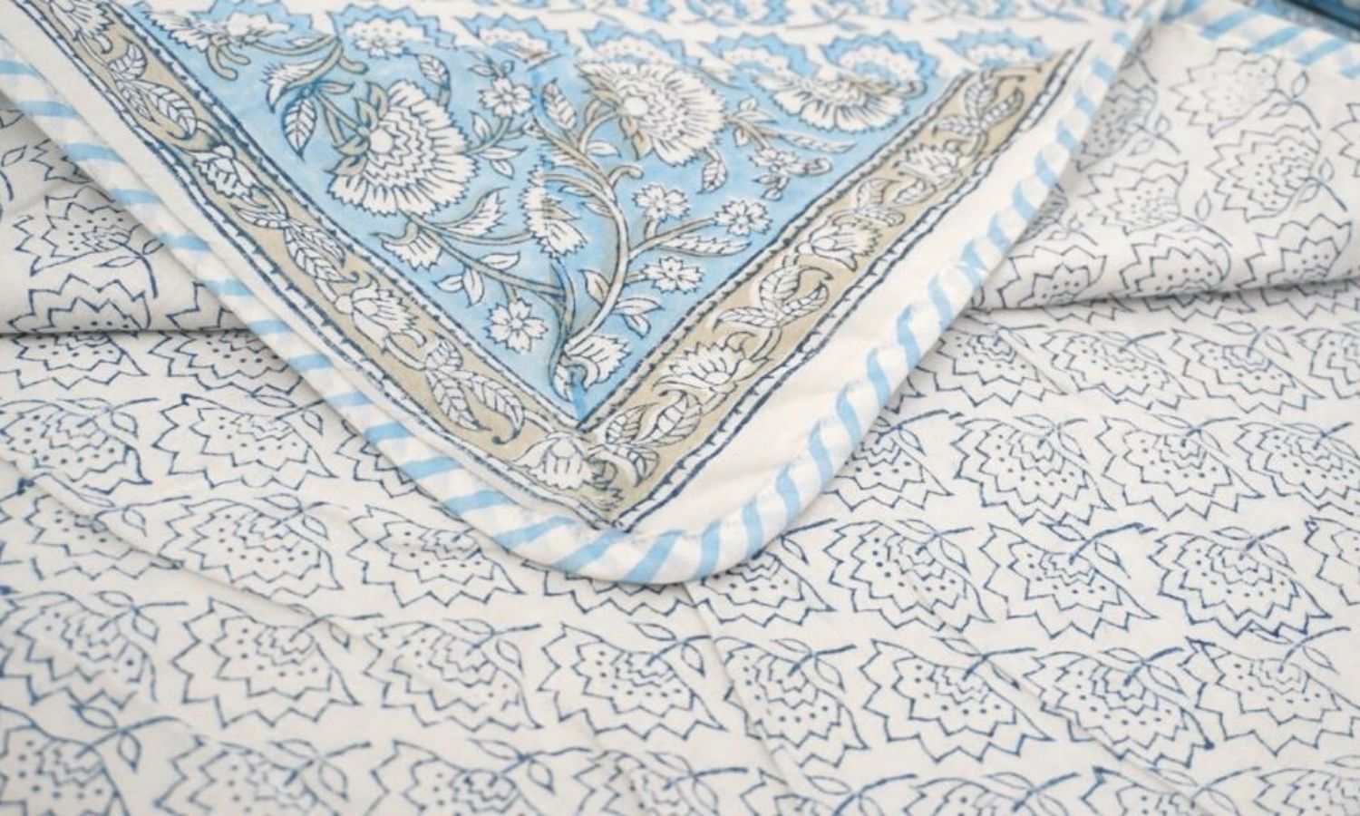 Dohar (lightweight cotton quilt) folded showing pattern repeat of hand block print | Myyra Jaipur