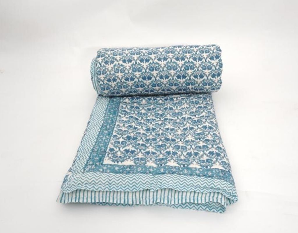 Folded organic cotton quilt showing block printed repeat | Myyra Jaipur
