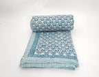 Folded organic cotton quilt showing block printed repeat | Myyra Jaipur