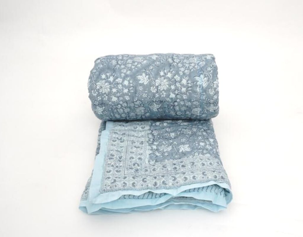 Folded organic cotton quilt showing block printed repeat | Myyra Jaipur