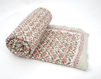 Folded organic cotton quilt showing block printed repeat | Myyra Jaipur