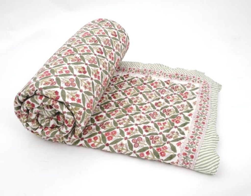 Folded organic cotton quilt showing block printed repeat | Myyra Jaipur
