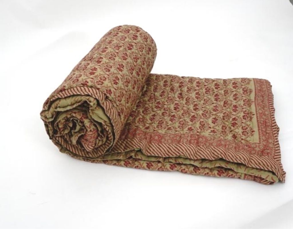 Folded organic cotton quilt showing block printed repeat | Myyra Jaipur