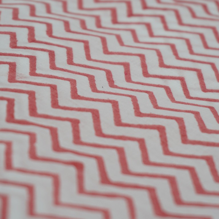 Folded hand block printed organic cotton yardage showing pattern repeat | Myyra Jaipur