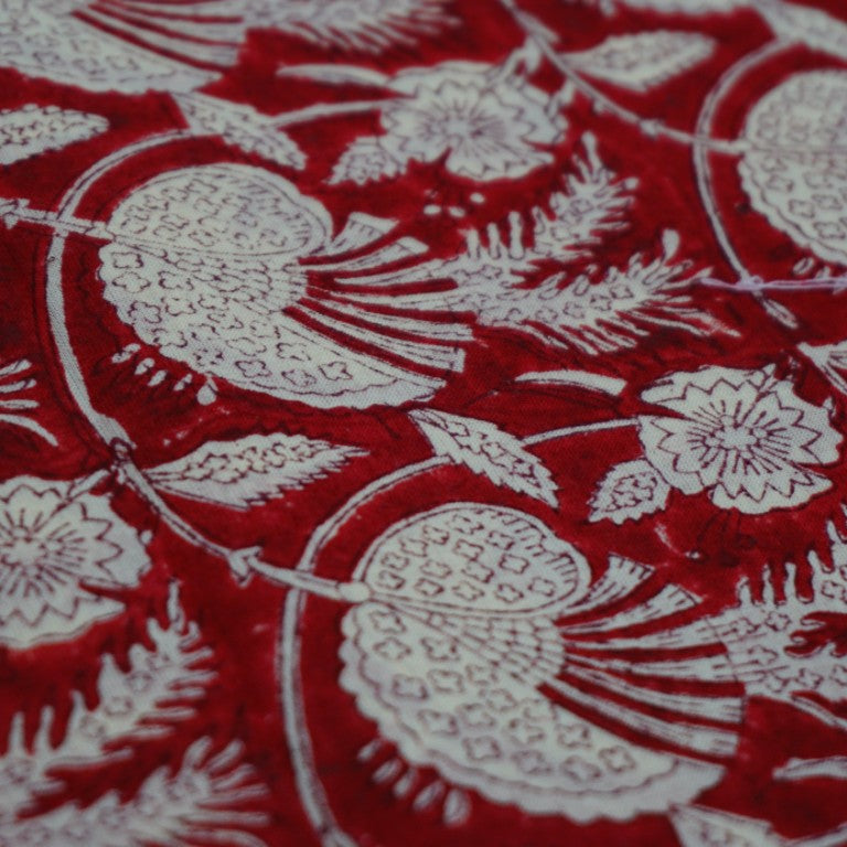 Folded hand block printed organic cotton yardage showing pattern repeat | Myyra Jaipur