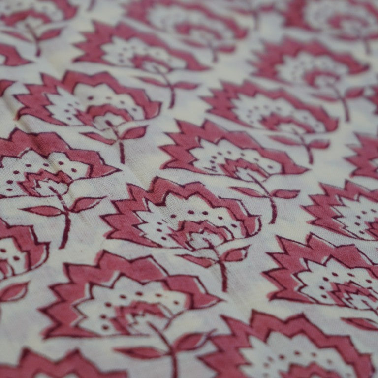 Folded hand block printed organic cotton yardage showing pattern repeat | Myyra Jaipur