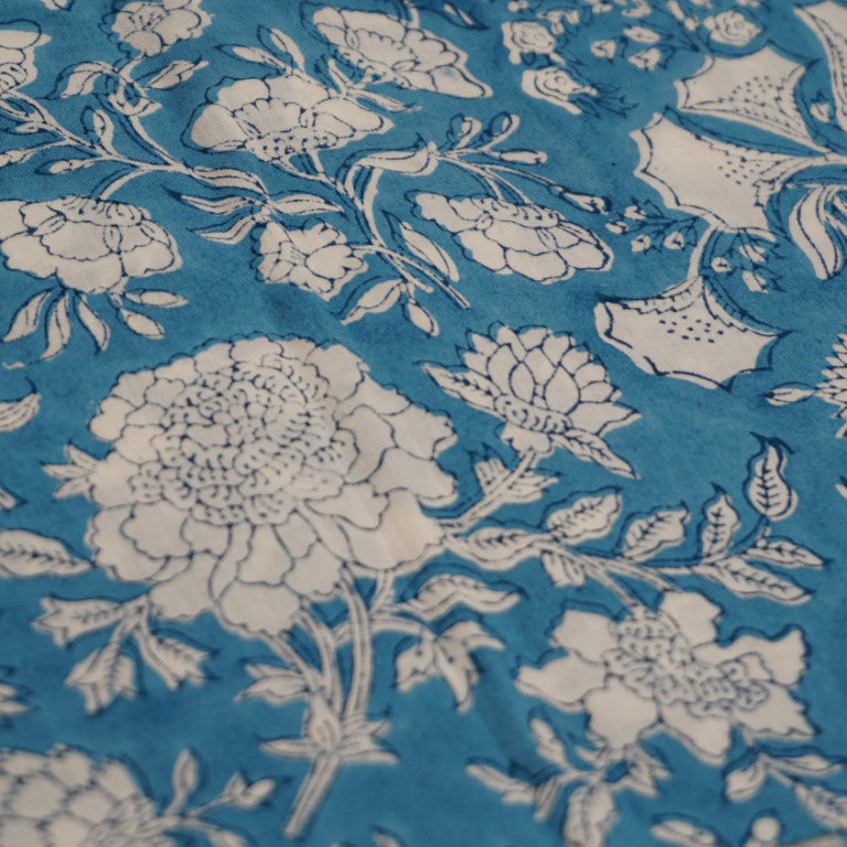 Folded hand block printed organic cotton yardage showing pattern repeat | Myyra Jaipur