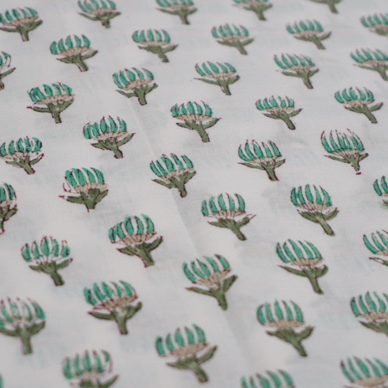Folded hand block printed organic cotton yardage showing pattern repeat | Myyra Jaipur