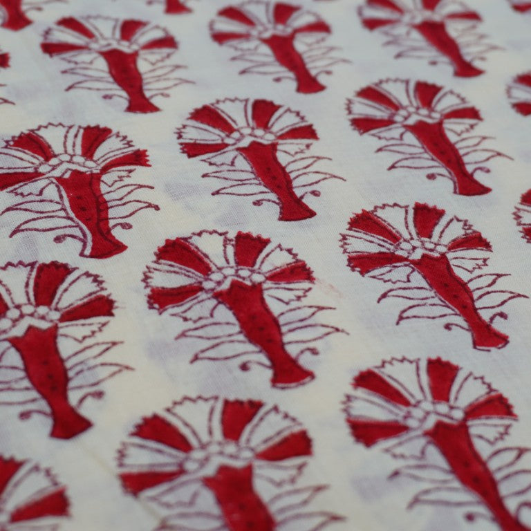 Folded hand block printed organic cotton yardage showing pattern repeat | Myyra Jaipur