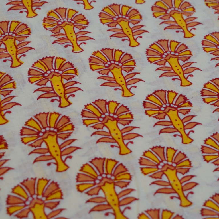 Folded hand block printed organic cotton yardage showing pattern repeat | Myyra Jaipur