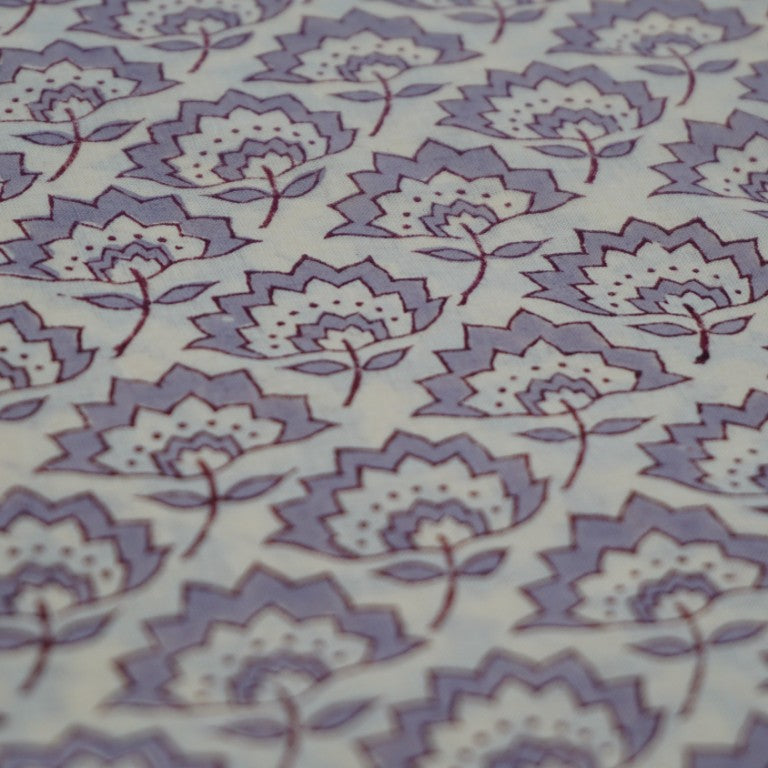 Folded hand block printed organic cotton yardage showing pattern repeat | Myyra Jaipur