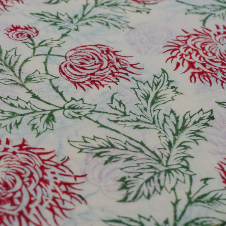 Folded hand block printed organic cotton yardage showing pattern repeat | Myyra Jaipur