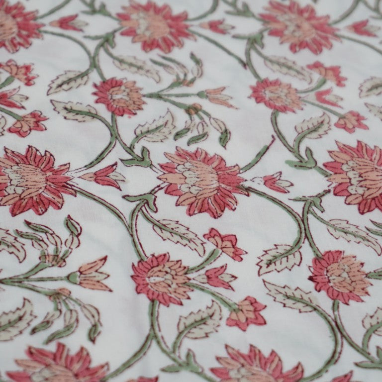 Folded hand block printed organic cotton yardage showing pattern repeat | Myyra Jaipur