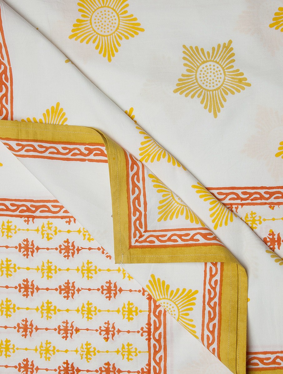 Close-up of white, yellow and orange hand block print on organic cotton bed cover | Myyra Jaipur