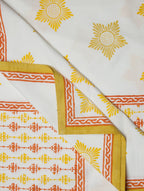 Close-up of white, yellow and orange hand block print on organic cotton bed cover | Myyra Jaipur