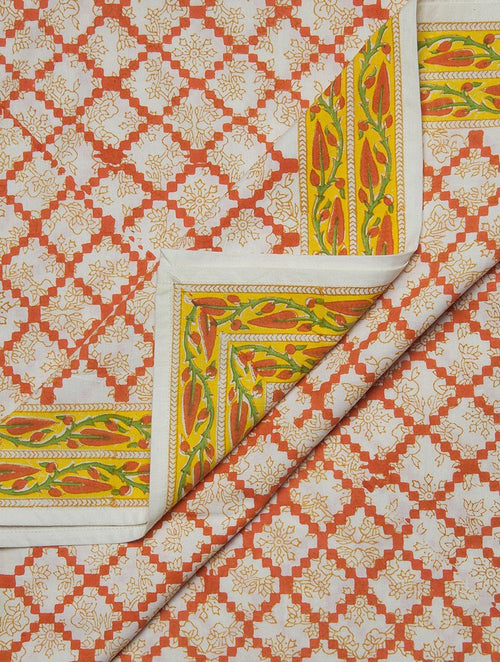 Close-up of cyan, white and orange hand block print on cotton bed sheet | Myyra Jaipur