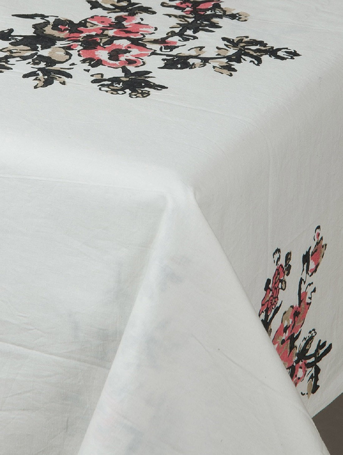 Close-up of white, black and pink hand block print on organic cotton table cover | Myyra Jaipur