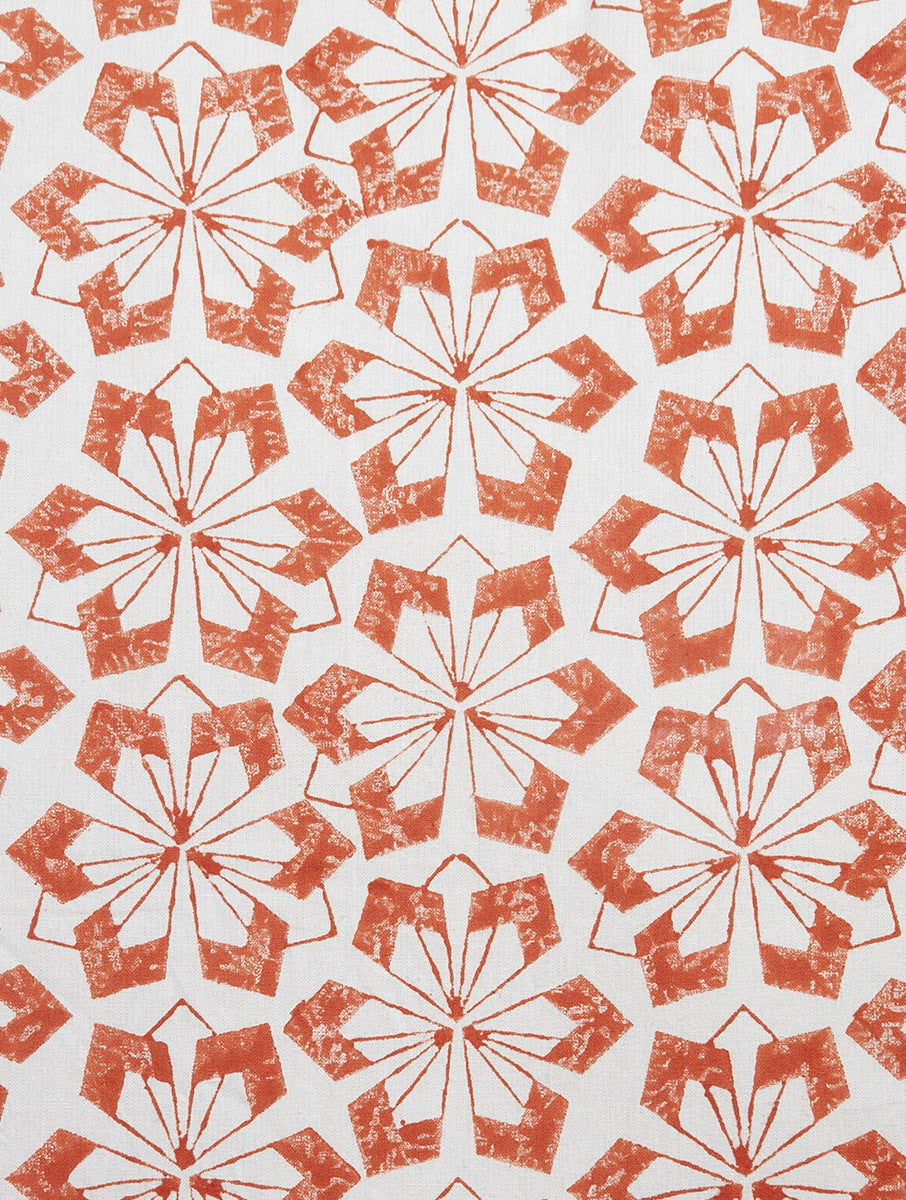 Close-up of orange hand block print on organic cotton cushion cover | Myyra Jaipur