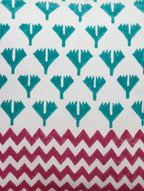 Close-up of red, green and white hand block print on organic cotton cushion cover | Myyra Jaipur