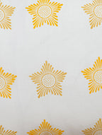 Close-up of yellow, white and orange hand block print on organic cotton pillow cover | Myyra Jaipur
