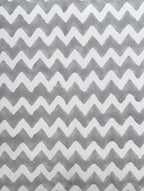 Close-up of grey zigzag hand block print on organic cotton cushion cover | Myyra Jaipur