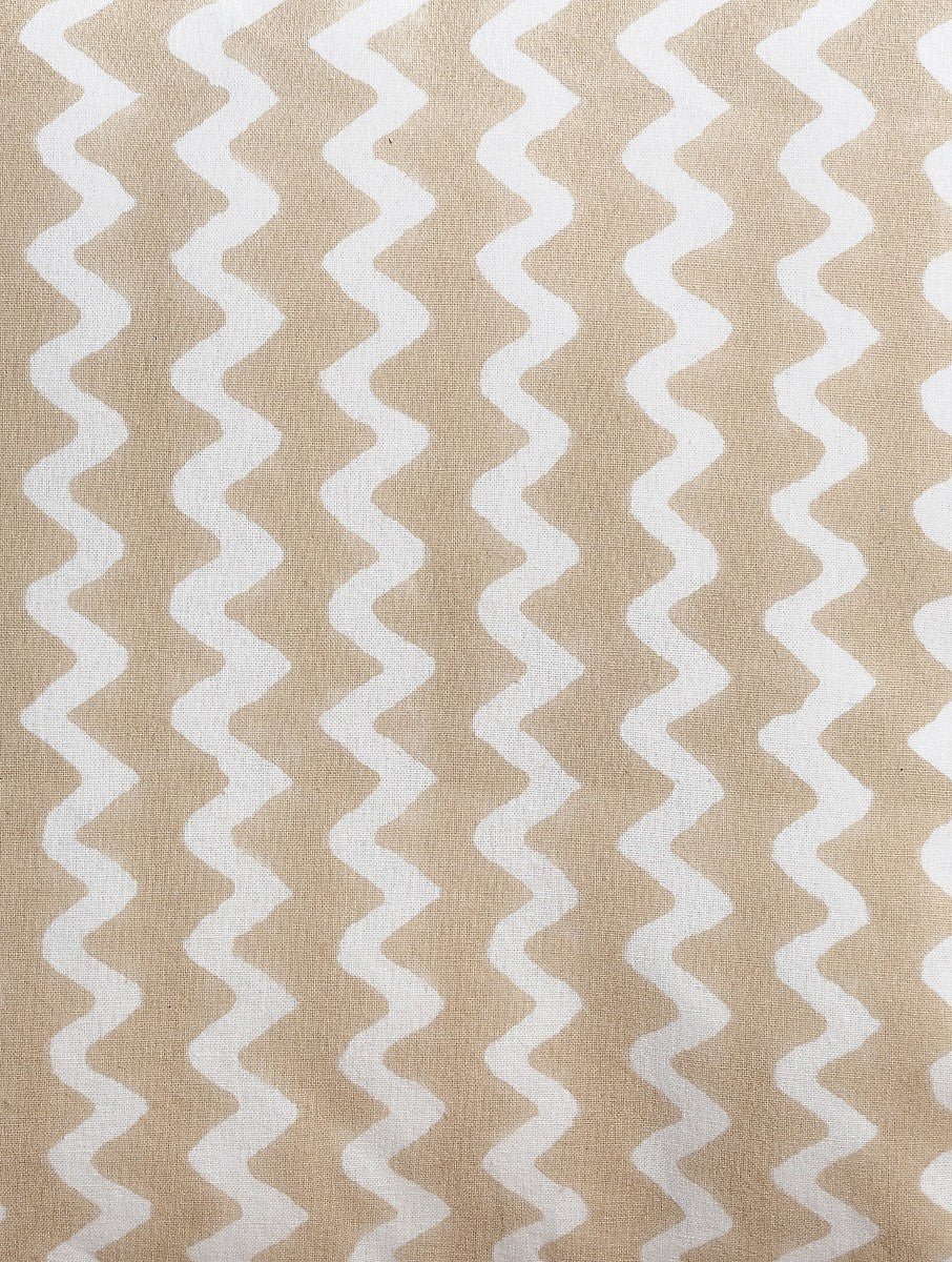 Close-up of beige zigzag hand block print on organic cotton cushion cover | Myyra Jaipur