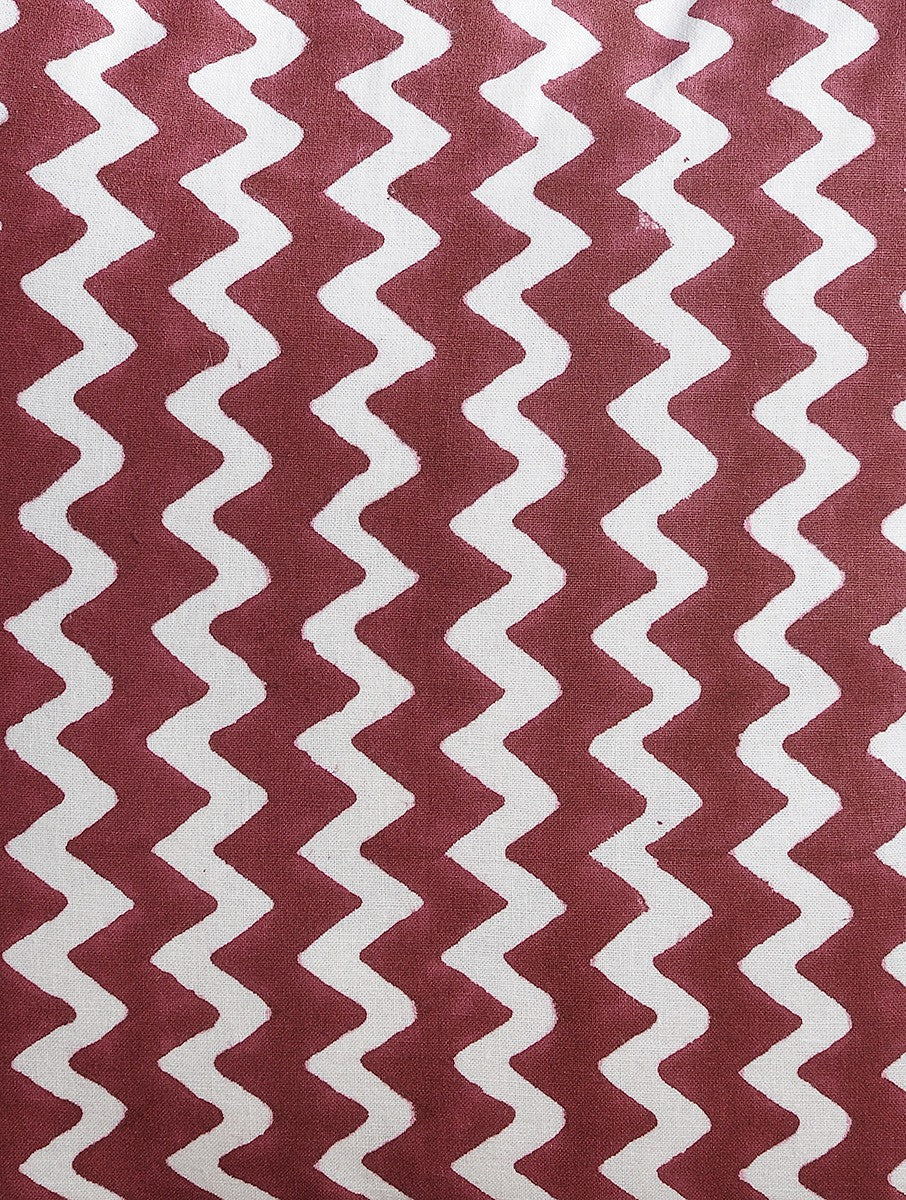 Close-up of maroon zigzag hand block print on organic cotton cushion cover | Myyra Jaipur