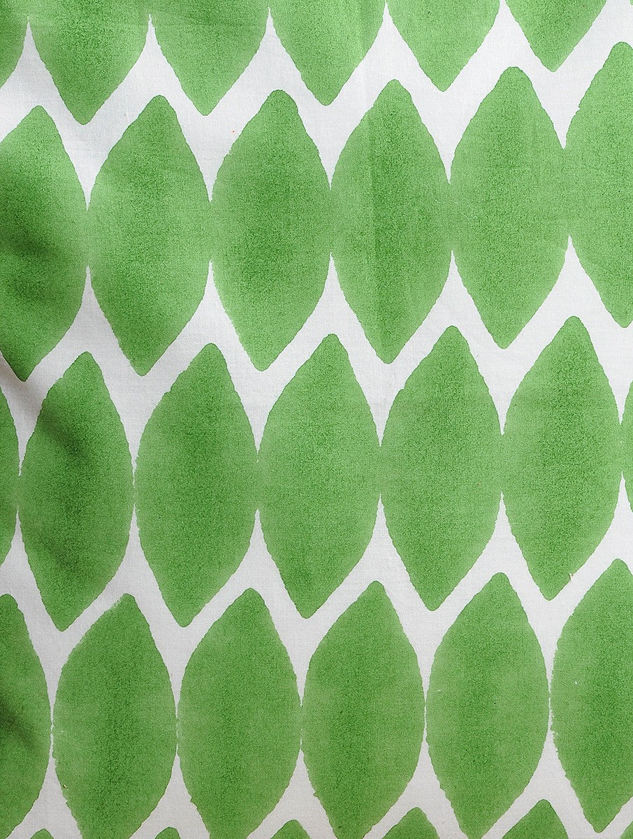 Close-up of white and green hand block print on organic cotton cushion cover | Myyra Jaipur